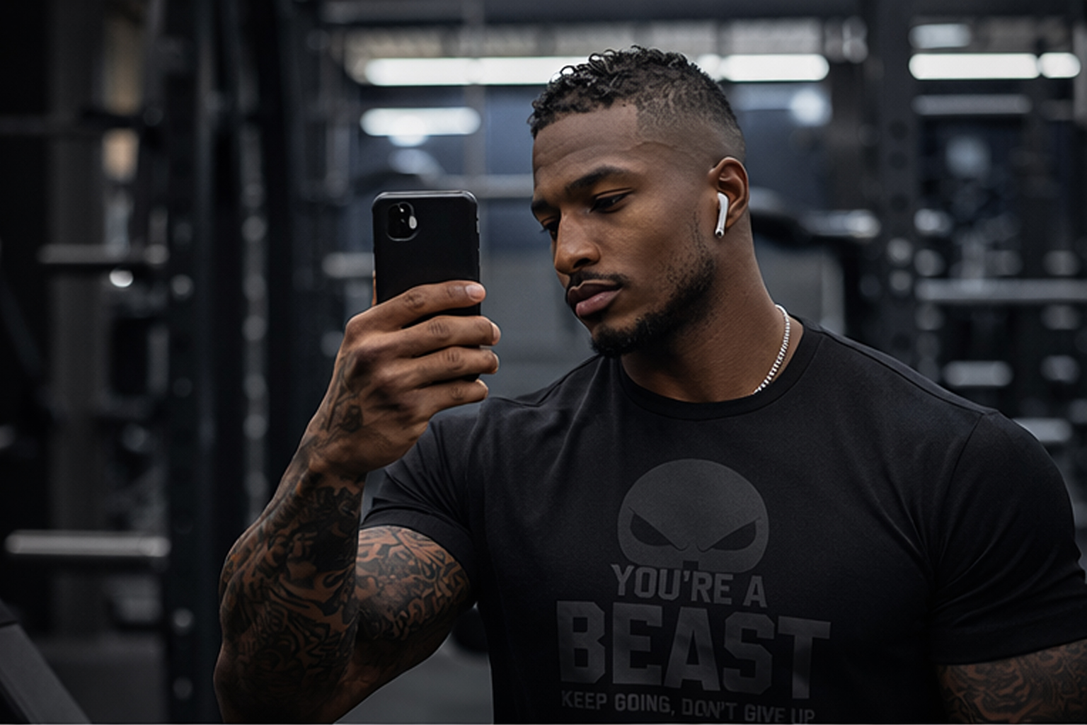 You’re A Beast Gym T-Shirt – Black on Black Motivational Workout Tee (Unisex) 2 Gym mirror selfie of a muscular man wearing a black on black You’re A Beast motivational t-shirt